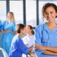 A beautiful nurse in a classroom wearing her medical apparel also known as doctor scrubs
