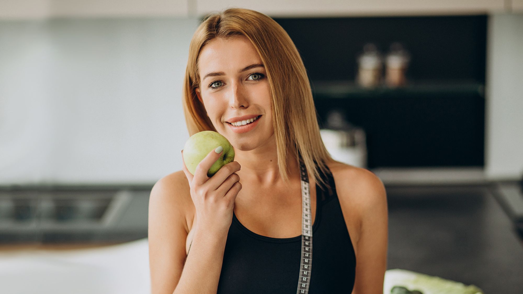 A woman holding a green apple unlocking the secrets of sassasse