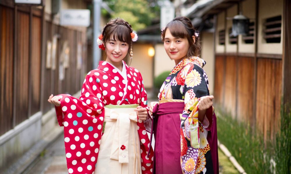 Two Japanese girls showcasing Asian fashion tapestry