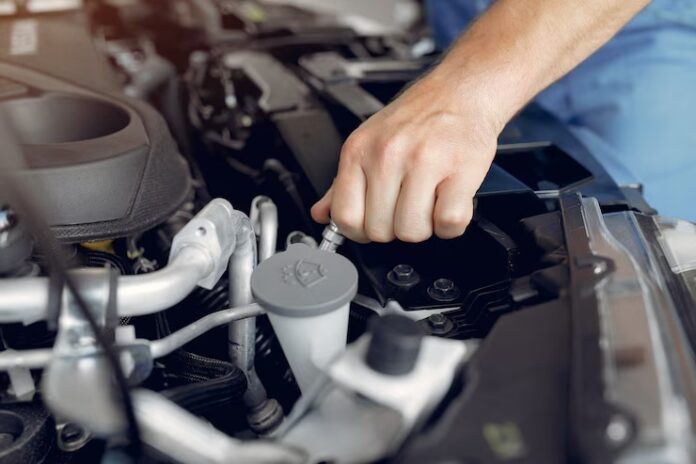 Man busy in car engine reconditioning