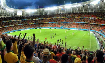A packed soccer stadium with fans cheering during a sporting event